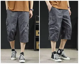Detail of men's grey washed cargo shorts featuring multiple pockets and loose fit