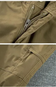 Detailed close-up of durable metal zipper and pocket stitching on outdoor softshell pants