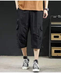 Detailed view of men's loose black cargo shorts with a comfortable 7-length summer fit