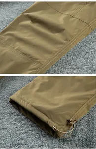 Close-up detail of men's fleece-lined outdoor softshell pants with drawstring cuff