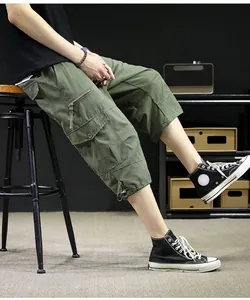 Close-up view of olive green cargo capri pants highlighting the side pocket detail