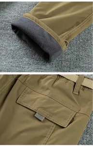 Close-up detail of men's outdoor softshell pants with warm fleece lining and pocket.
