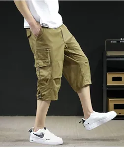 Detailed side view of khaki multi-pocket cargo shorts with adjustable drawstring hem