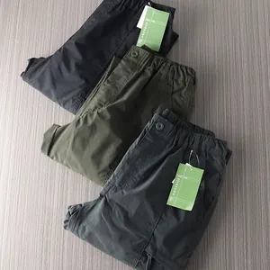 Detailed view of lightweight outdoor cargo pants in black, green, and grey