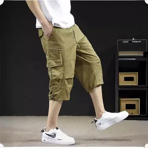 Lightweight men's loose cargo 3/4 capri pants in khaki color shown on a model side view.