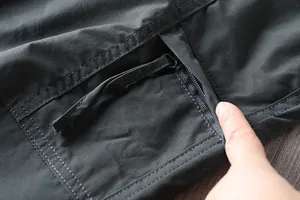 Close-up view of a functional zipper pocket on mens outdoor hiking cargo pants