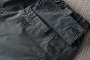 Macro detail of a durable cargo pocket with Velcro closure on men's hiking pants