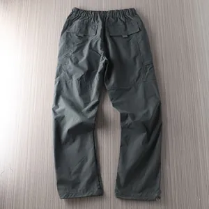 Detailed back view of men's quick-dry outdoor hiking pants featuring flap pockets and elastic waist