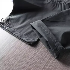 Main view of men's waterproof hiking pants showing quick-dry fabric and drawstring hem