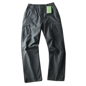 Men's waterproof outdoor cargo pants in dark grey with multi-pockets and adjustable hem