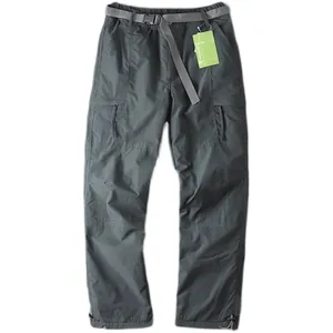 Detailed view of gray outdoor cargo pants with adjustable nylon belt and utility pockets