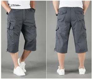 Men's grey cargo capri pants featuring multiple utility pockets and a relaxed fit.