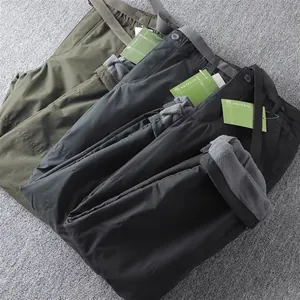 Close-up detail of men's thermal cargo pants with soft fleece lining and multiple colors