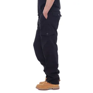 Detailed side view of loose fit black cotton cargo pants with functional flap pockets.
