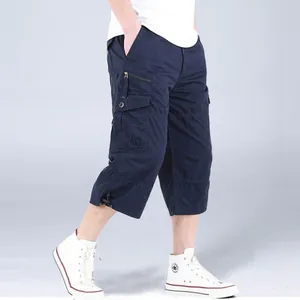 Side view of navy blue cargo cropped pants with multiple pockets and drawstring hem.