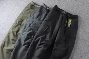 Macro view showing textured men's multi-pocket straight leg cargo pants in three colors.