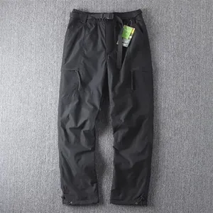 Detail view of black straight-leg cargo pants with multi-pockets and adjustable belt.