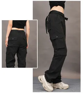 Detailed view of women's black multi-pocket convertible cargo pants for hiking