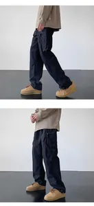 Detail view of black outdoor tactical cargo pants with side pockets and drawstring hem.