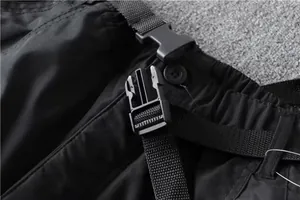 Close-up detail of plastic buckle and nylon belt on black tactical cargo pants
