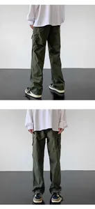 Front and back view of dark green outdoor cargo pants on model in studio setting