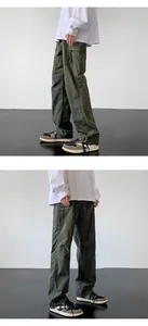 Close-up of olive green cargo pants with drawstring hem and utility pockets
