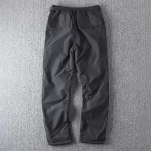 Back view of men's black straight-leg tactical cargo pants with functional large flap pockets
