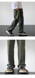 Detail of olive green cargo pants featuring adjustable hems and functional side pockets.