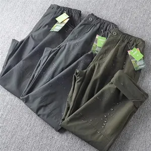 Close-up detail of waterproof quick-dry cargo pants with water droplets on surface