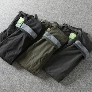 Detailed view of men's waterproof fleece-lined softshell pants in multiple color options