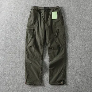 Full front view of olive green cargo pants showing pockets and belt assembly detail
