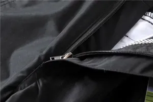 Macro detail showing high-quality metal zipper on black men's outdoor cargo pants