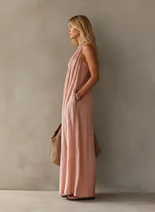 Elegant sleeveless pink pleated maxi dress featuring a draped silhouette and side pocket