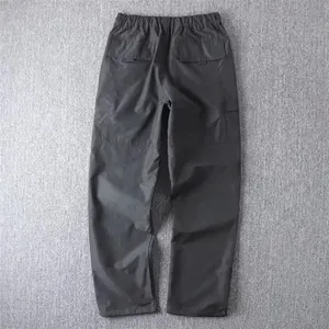 Back view of men's straight-leg cargo pants with flap pockets showing construction.