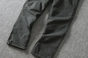 Close-up detail of windproof outdoor softshell pants featuring an adjustable drawstring hem