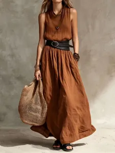 Detailed view of a sleeveless French style linen maxi dress in caramel brown with belt.