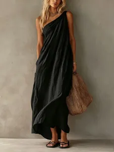Detail view of elegant black one-shoulder maxi dress with a relaxed fit and textured fabric.