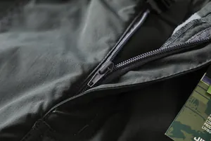 Close-up of durable zipper and high-quality fabric on men's outdoor softshell pants