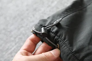 Close-up of adjustable drawstring cuff on windproof outdoor softshell pants