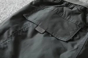 Close-up detail of the back pocket and durable fabric on outdoor softshell pants.
