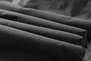 Detailed close-up of windproof and waterproof softshell fabric for men's winter pants