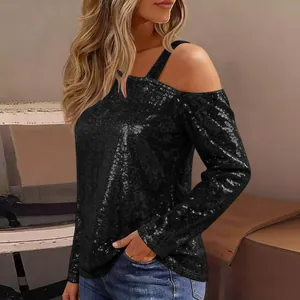 Detailed view of women's black sequin long sleeve top with cold shoulder strap