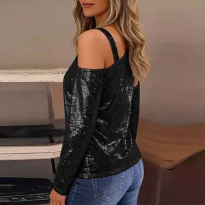 Detail view of stylish black sequined long-sleeve top with cold-shoulder strap design