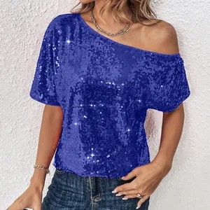 Detail view of the shimmering blue sequin texture on this off-shoulder women's top.