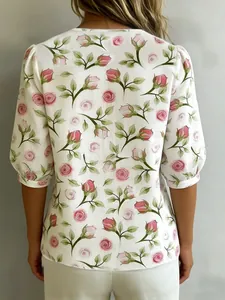 Back view of a white puff-sleeve blouse with pink rose floral pattern print