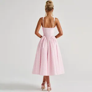 Back view of a pink French gingham backless sundress with pleated skirt details