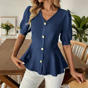 Close-up showing the textured fabric and button detail of a blue puff sleeve blouse.
