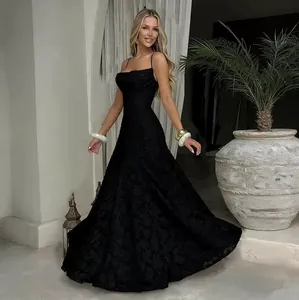 Elegant black spaghetti strap maxi dress featuring intricate textured jacquard fabric detail.