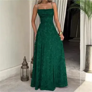 Detail of an elegant dark green floral jacquard maxi dress with thin straps