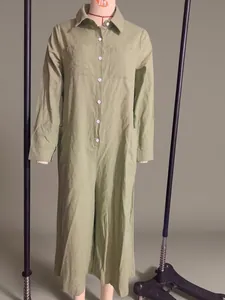 Front view of light green long sleeve cotton linen shirt jumpsuit on mannequin